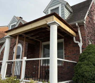 Front porch exterior repair including roof edge and structural detailing to restore durability and appearance. Front porch roof exterior repair on brick home with column support in Pittsburgh PA