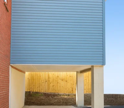 Clean and precise siding repair improving exterior protection and giving the home a refreshed look. Blue vinyl siding repair on residential exterior wall in Pittsburgh PA