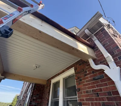 Front porch roof repair with soffit and fascia work on brick home in Pittsburgh PA”