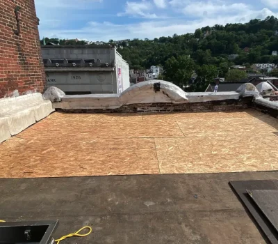 Flat roof restoration with new sheathing installed to improve structural integrity and waterproofing. Flat roof repair with new sheathing installation on commercial building in Pittsburgh PA