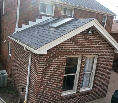 Newly installed asphalt shingle roof providing long-lasting protection and improved curb appeal New asphalt shingle roof installation on brick residential home in Pittsburgh PA